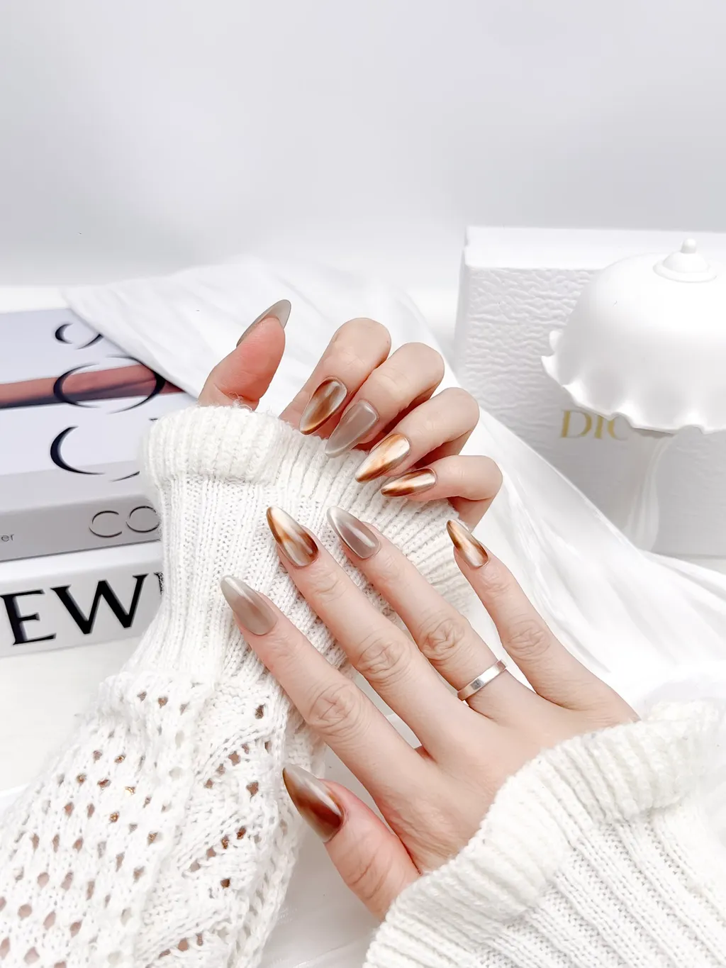 Hand-painted Aurelle press-on nails with a cat-eye finish